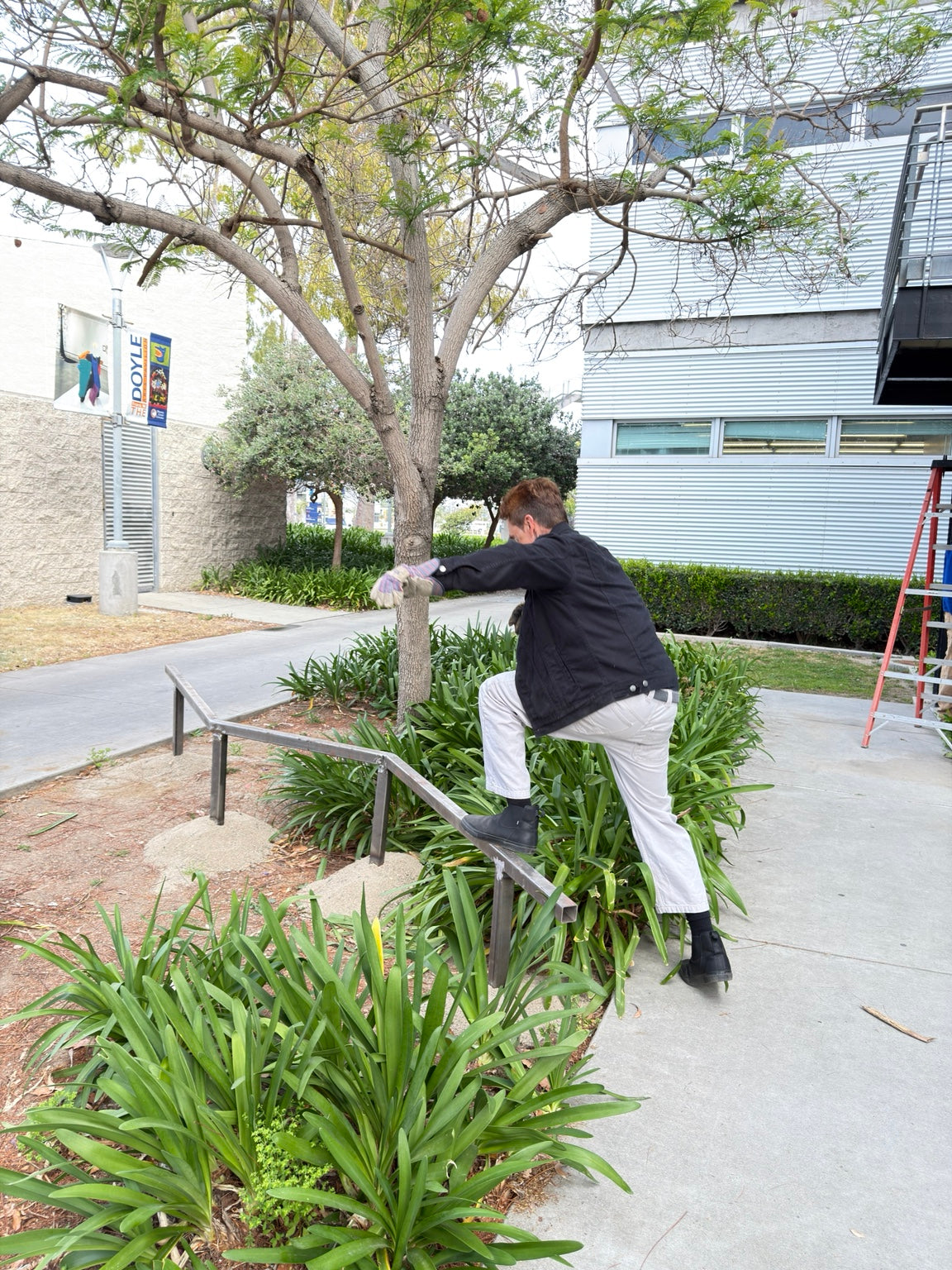 Bryan Foster interacting with a site-responsive steel sculpture